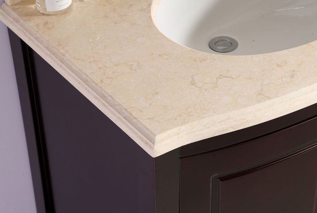 Close-up of a bathroom vanity with a light beige marble countertop, an oval sink, and a dark brown wood cabinet.