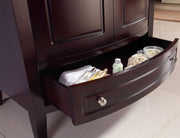 Open bathroom drawer in a dark wooden vanity.