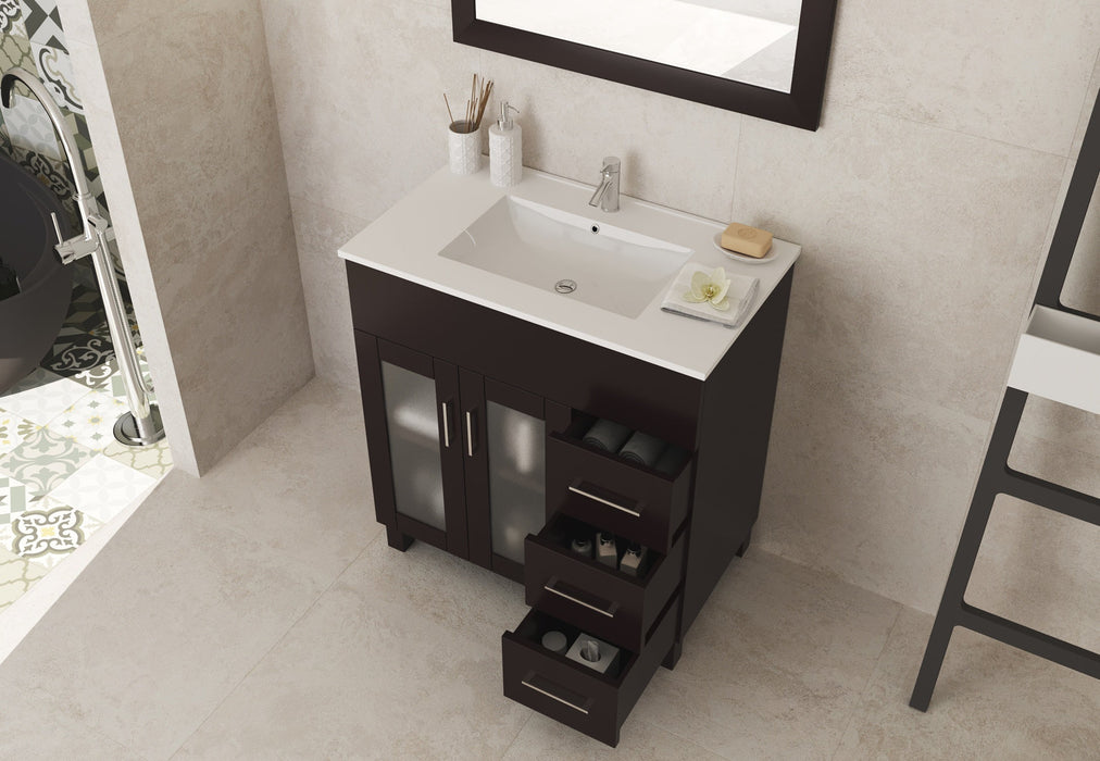 Bathroom vanity with open drawers, dark wood, and white countertop.