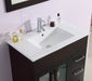 Bathroom vanity with white sink, brown cabinet, and silver fixtures.
