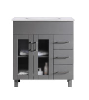 Gray bathroom vanity with white countertop and silver handles.