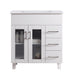 White bathroom vanity with three drawers and two glass-paneled doors.
