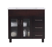 Dark wood vanity with white countertop, three drawers, and frosted glass doors.