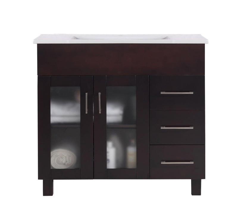 Dark wood vanity with white countertop, three drawers, and frosted glass doors.