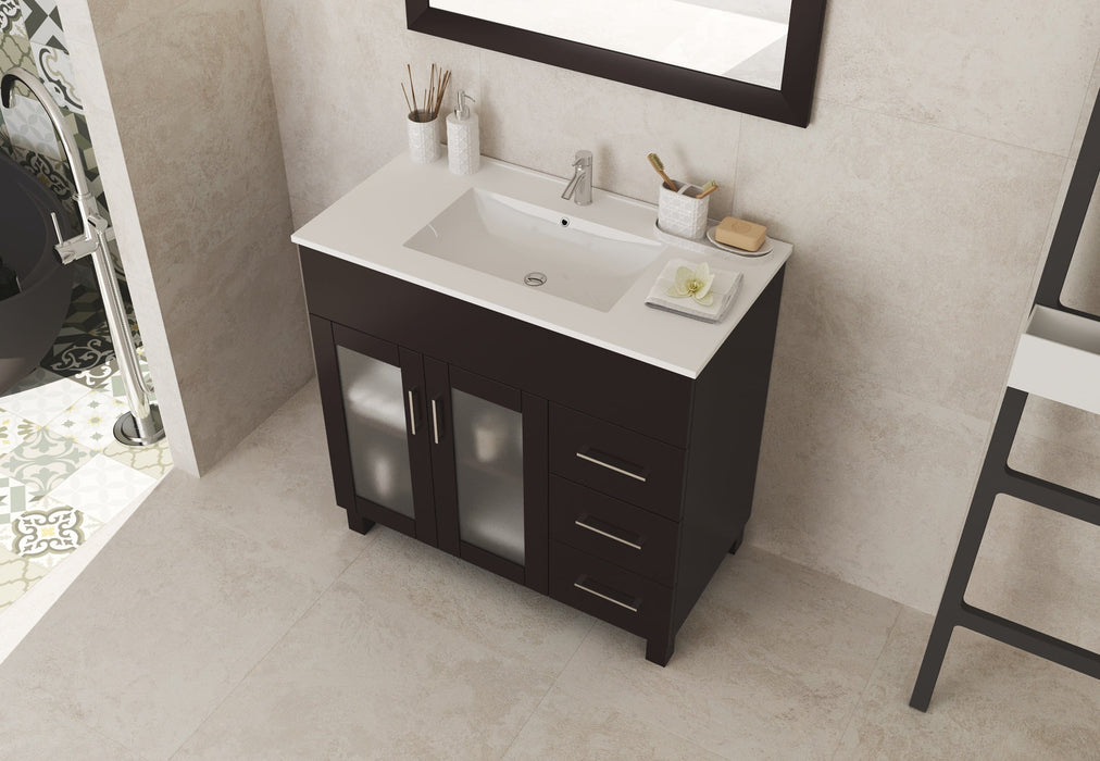 Bathroom vanity with dark wood cabinet, white countertop, and white sink.