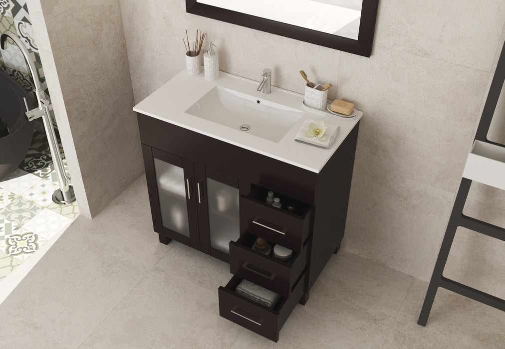 Bathroom vanity with sink, drawers open, displaying towels and accessories.