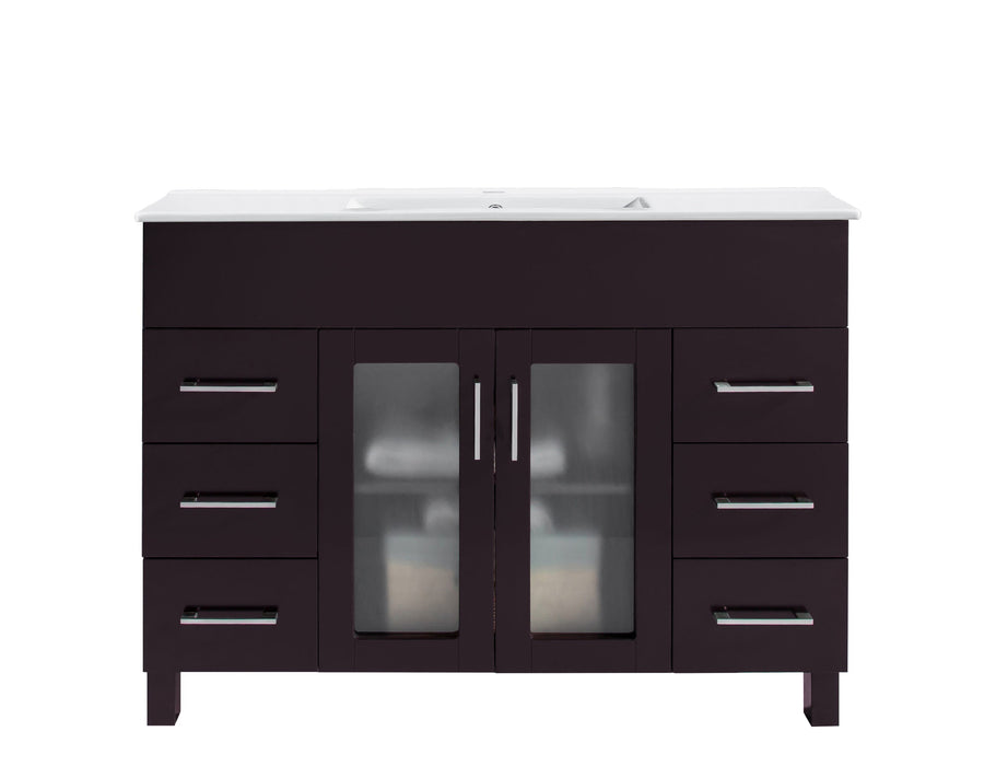 Dark brown bathroom vanity with white countertop, drawers, and glass-front cabinet doors.
