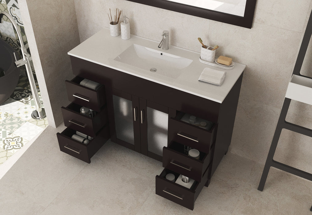 Bathroom vanity with open drawers, white countertop, and dark brown cabinet.