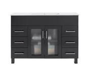 Black bathroom vanity with white countertop and silver handles.