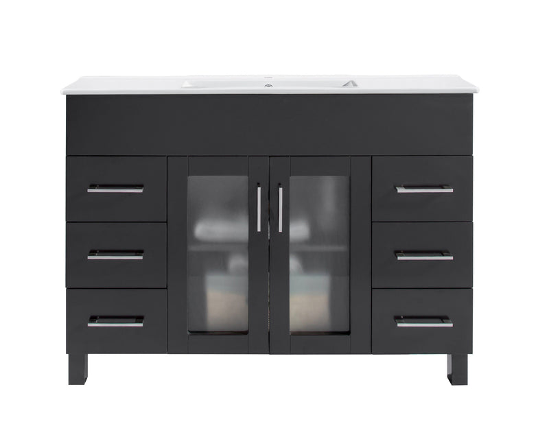 Black bathroom vanity with white countertop and silver handles.