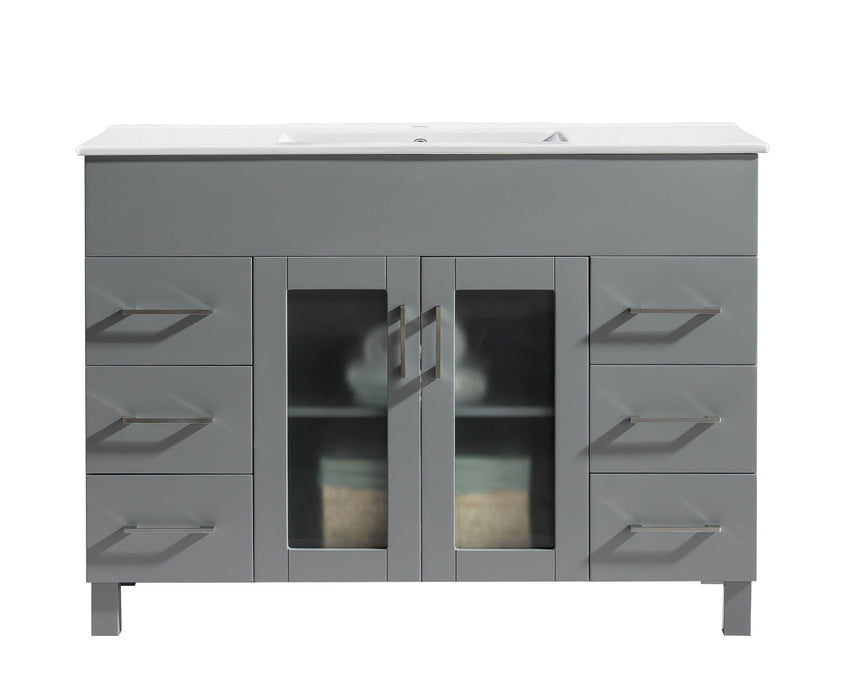 Gray bathroom vanity with white countertop and rectangular metal handles.