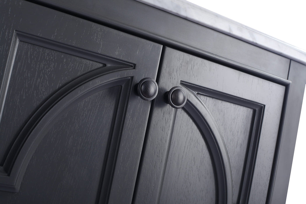 Gray wooden cabinet doors with round metal knobs.
