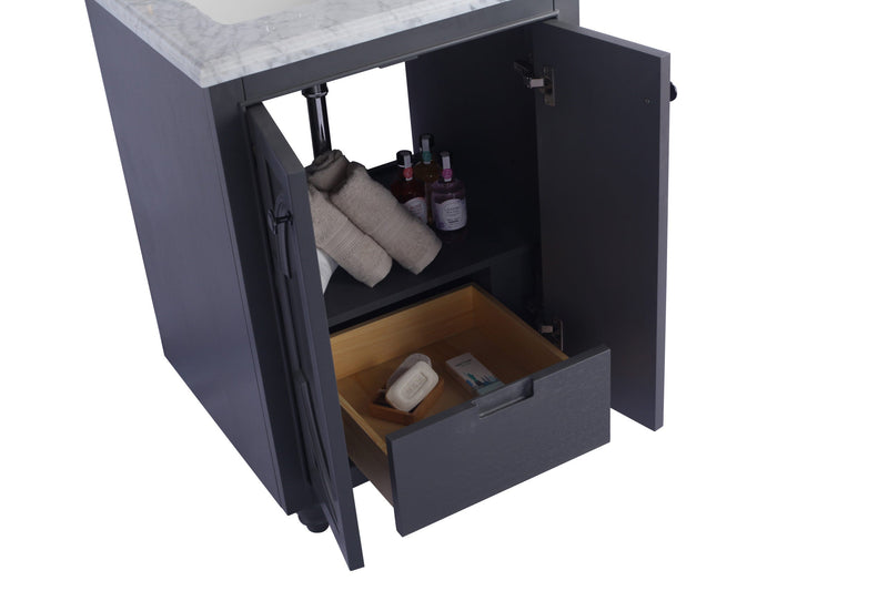 Gray bathroom vanity with marble top, open drawer, and cabinet doors.