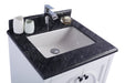 Bathroom vanity with black granite countertop and white sink.
