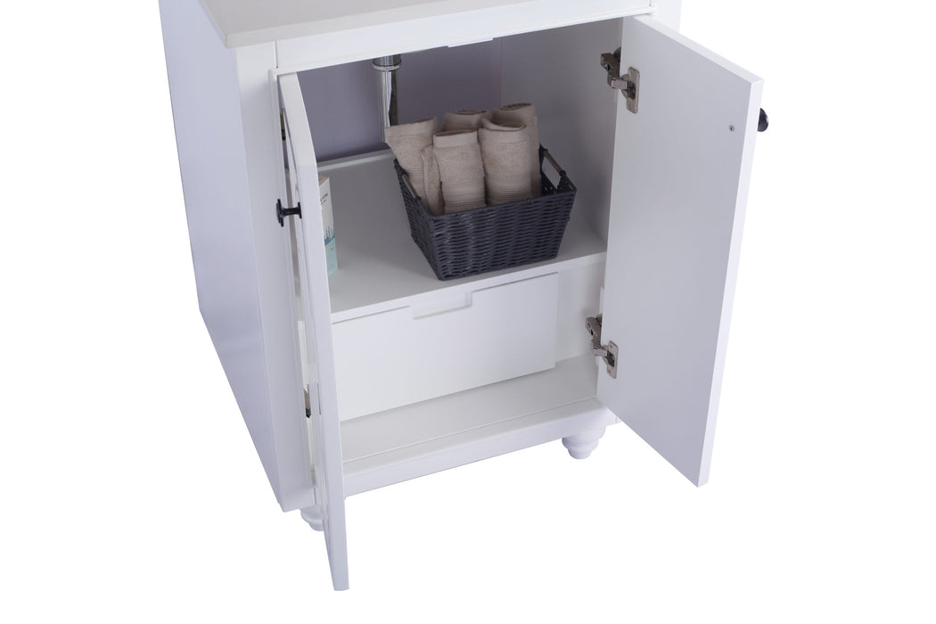 White vanity cabinet with open doors, revealing a drawer and a basket with rolled towels.