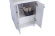 White vanity cabinet with open doors, revealing a drawer and a basket with rolled towels.