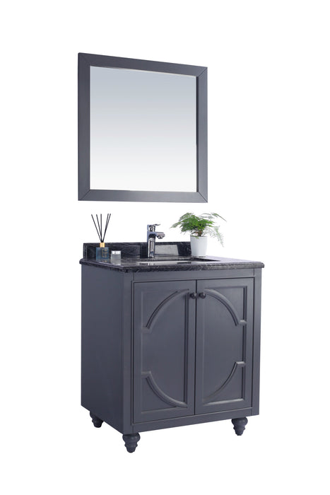 Bathroom vanity with mirror, gray cabinet, dark countertop, and small potted plant.