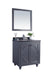 Bathroom vanity with mirror, gray cabinet, dark countertop, and small potted plant.
