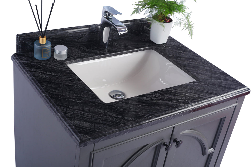 Bathroom vanity with a black marbled countertop, white sink, chrome faucet, and gray cabinet.