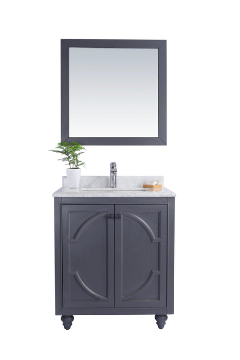 Freestanding gray bathroom vanity with mirror and plant.