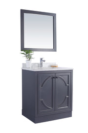 Bathroom vanity with a gray cabinet and a matching framed mirror.