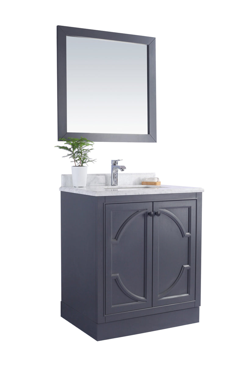 Bathroom vanity with a gray cabinet and a matching framed mirror.