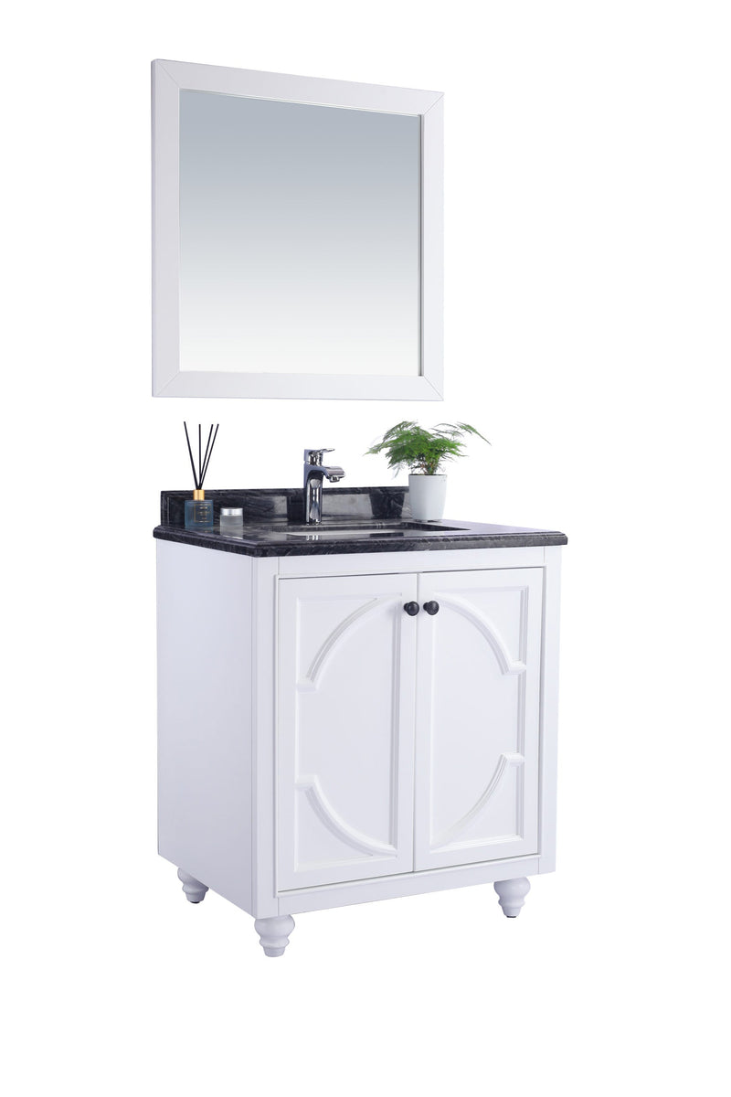 White bathroom vanity with a black countertop and a framed square mirror above.