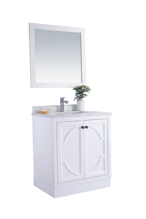 White vanity with marble top and mirror.
