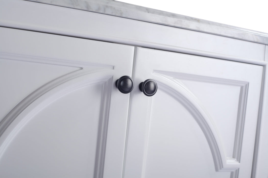 White cabinet doors with black round knobs.

