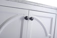 White cabinet doors with black round knobs.
