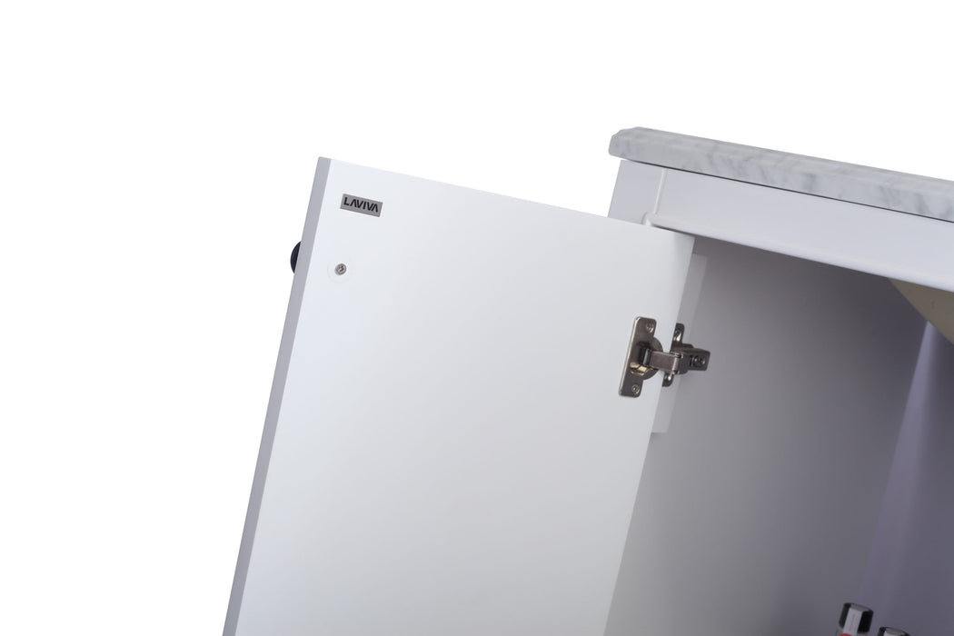 Open white cabinet with silver hinges and gray countertop.