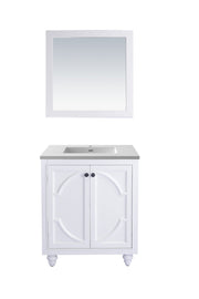 White bathroom vanity with gray countertop and white framed mirror.