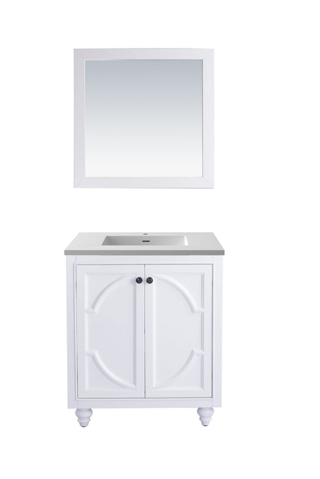 White bathroom vanity with gray countertop and white framed mirror.
