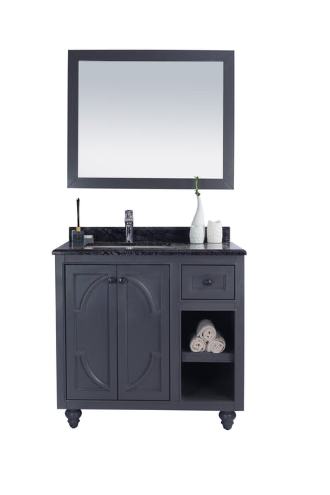 Freestanding navy bathroom vanity with black granite countertop and mirror.