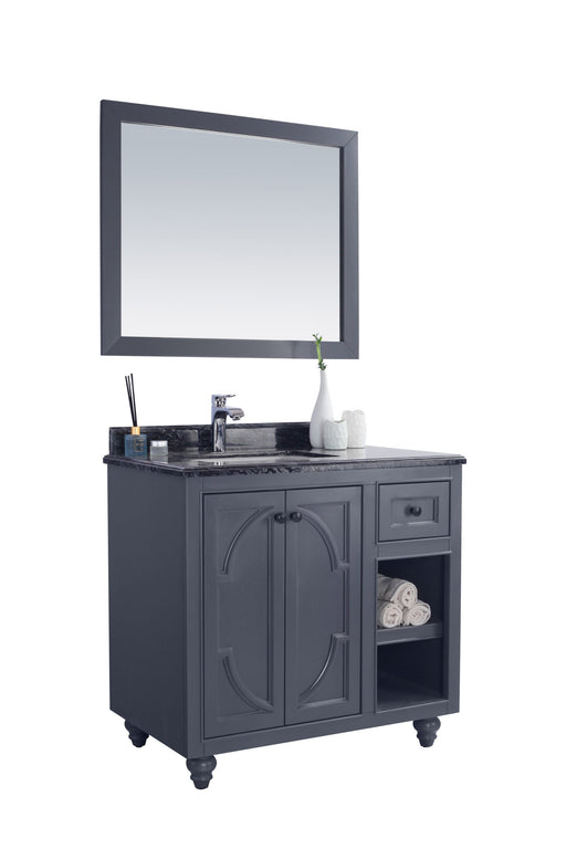 Bathroom vanity with gray cabinet, marble countertop, and matching mirror.