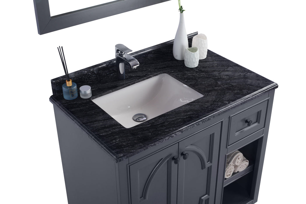 Bathroom vanity with granite top, sink, and storage.
