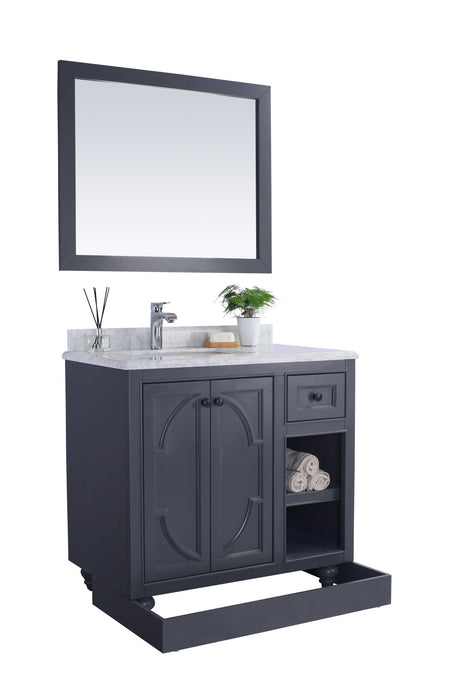 Bathroom vanity with gray cabinet, marble countertop, and mirror.
