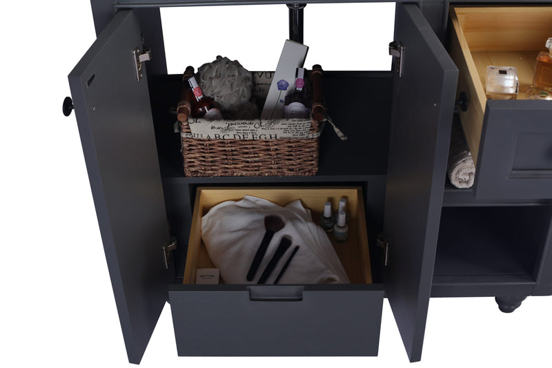 Open-doored grey vanity with wicker basket, cosmetics, rolled towel, and white cloth.