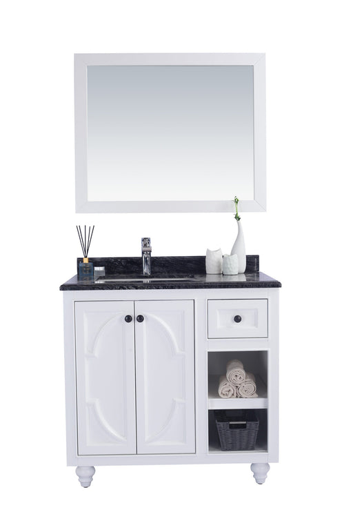 A white bathroom vanity with a black countertop and a matching mirror.