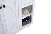 White bathroom vanity with towels and a woven basket.