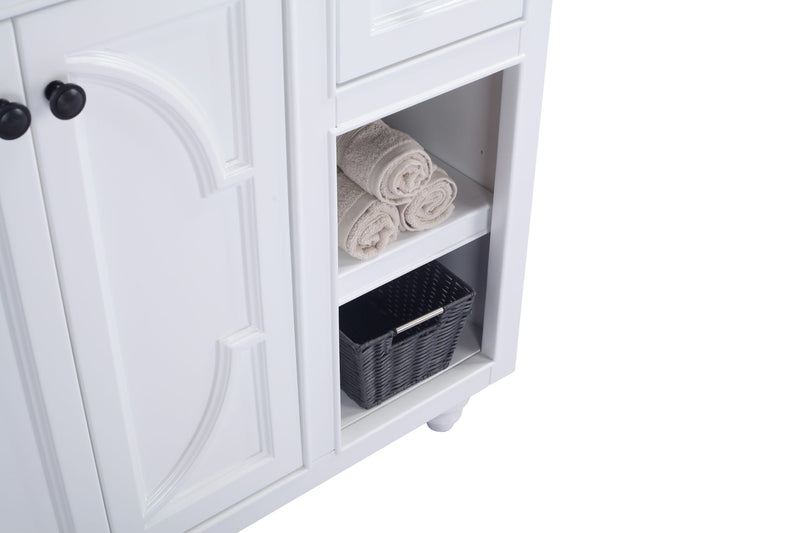 White bathroom vanity with towels and a woven basket.