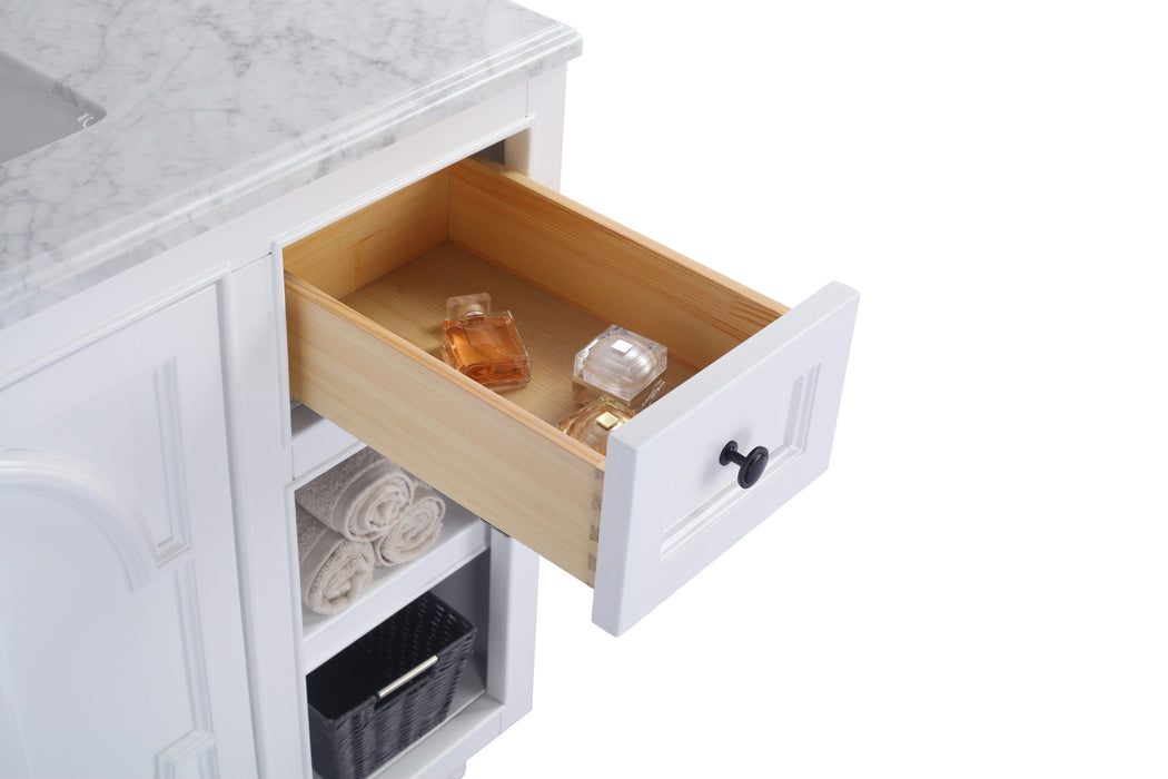 Bathroom vanity with open drawer containing toiletries.