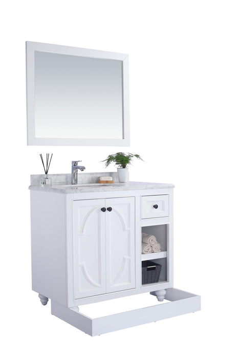 White bathroom vanity with marble countertop and matching mirror.