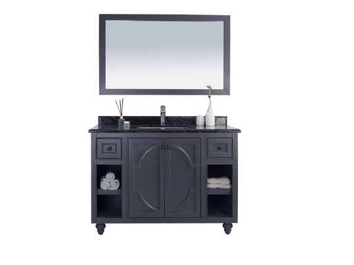 A dark grey vanity with a marble countertop and a rectangular mirror.