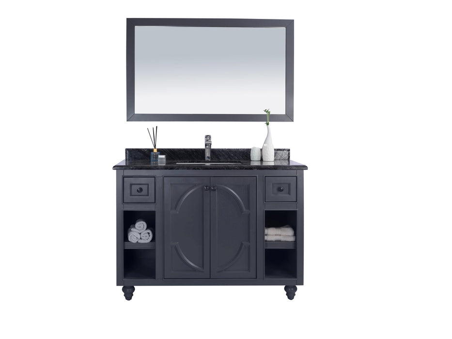 A dark grey vanity with a marble countertop and a rectangular mirror.