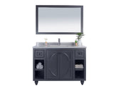 Gray bathroom vanity with mirror and towels.
