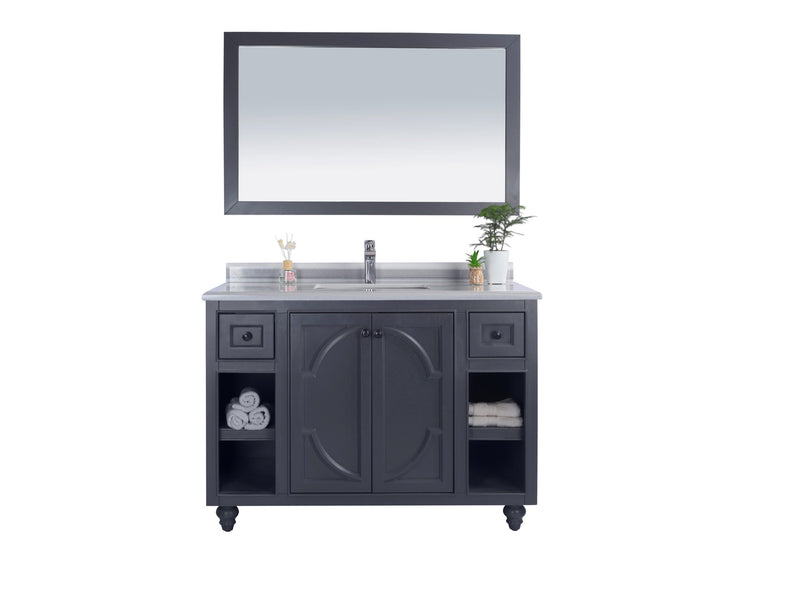 Gray bathroom vanity with mirror and towels.

