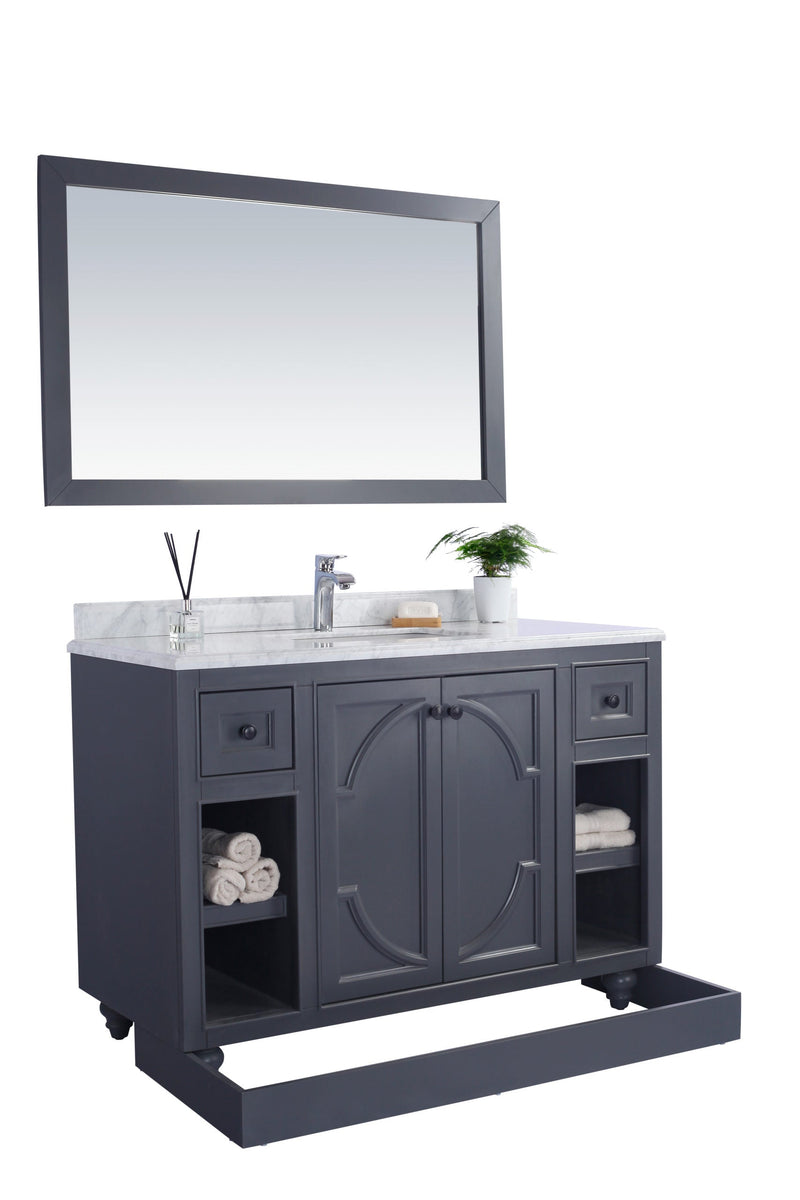 Gray bathroom vanity with white countertop and mirror.