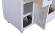 White vanity with open cabinet and shelves.  Gray wicker basket with towel.  Open drawer.