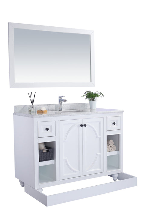 White bathroom vanity with marble countertop and mirror.